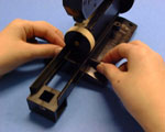inserting screw to secure rail to ScoreOne body
